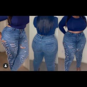 Distressed blue jeans with side rips